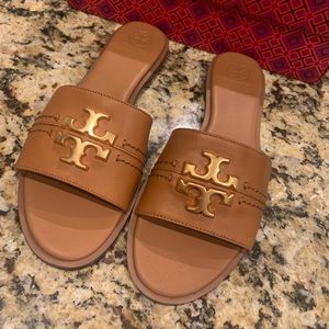 Tory Burch tan slides,brand new never worn .Comes in original packaging . Size9